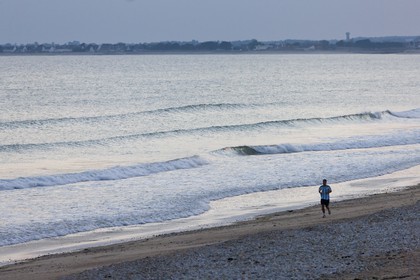 Jogger on the beach of Loch in Guidel.Morbihan